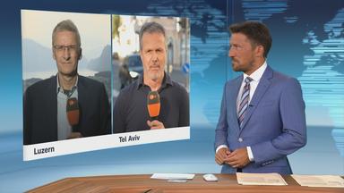 Die ZDF-Korrespondenten Elmar Theveßen und Thomas Reichart 