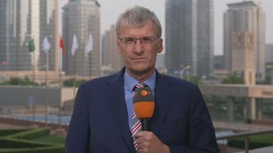 ZDF-Korrespondent Elmar Theveßen ist mit einem Mikrofon in der Hand in Peking zu sehen.
