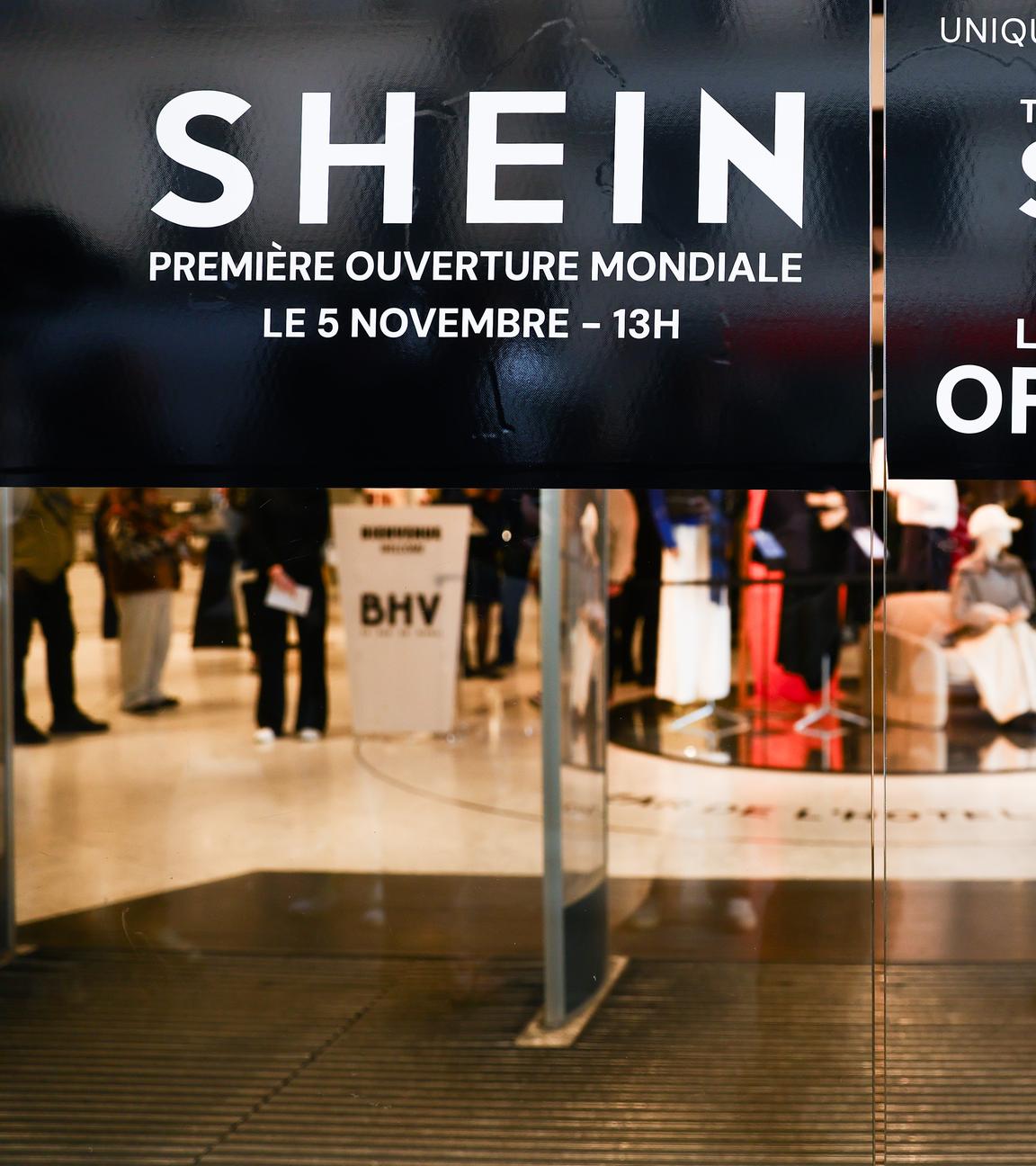 A sign informs customers about opening promotions on the opening day of Shein's first-ever physical store in Paris