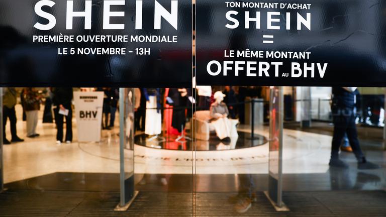 A sign informs customers about opening promotions on the opening day of Shein's first-ever physical store in Paris