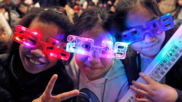 Chinesen tragen 2018-Brillen bei der Silvesterfeier in Hong Kong.