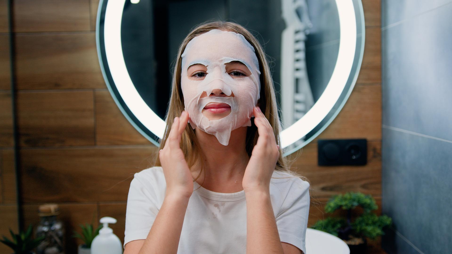 Mädchen trägt eine Gesichtsmaske auf.