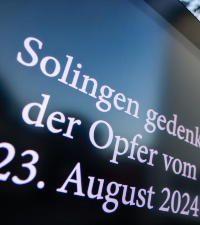 Auf einem Display auf dem Platz des Anschlags ist zu lesen: Solingen gedenkt der Opfer des Terroranschlags vom 23. August 2024.