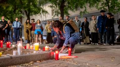 07.10.2026, Spanien, Madrid: Menschen stellen vor dem Haus, in dem Maricarmen Abascal in Madrid wohnte, Kerzen auf.