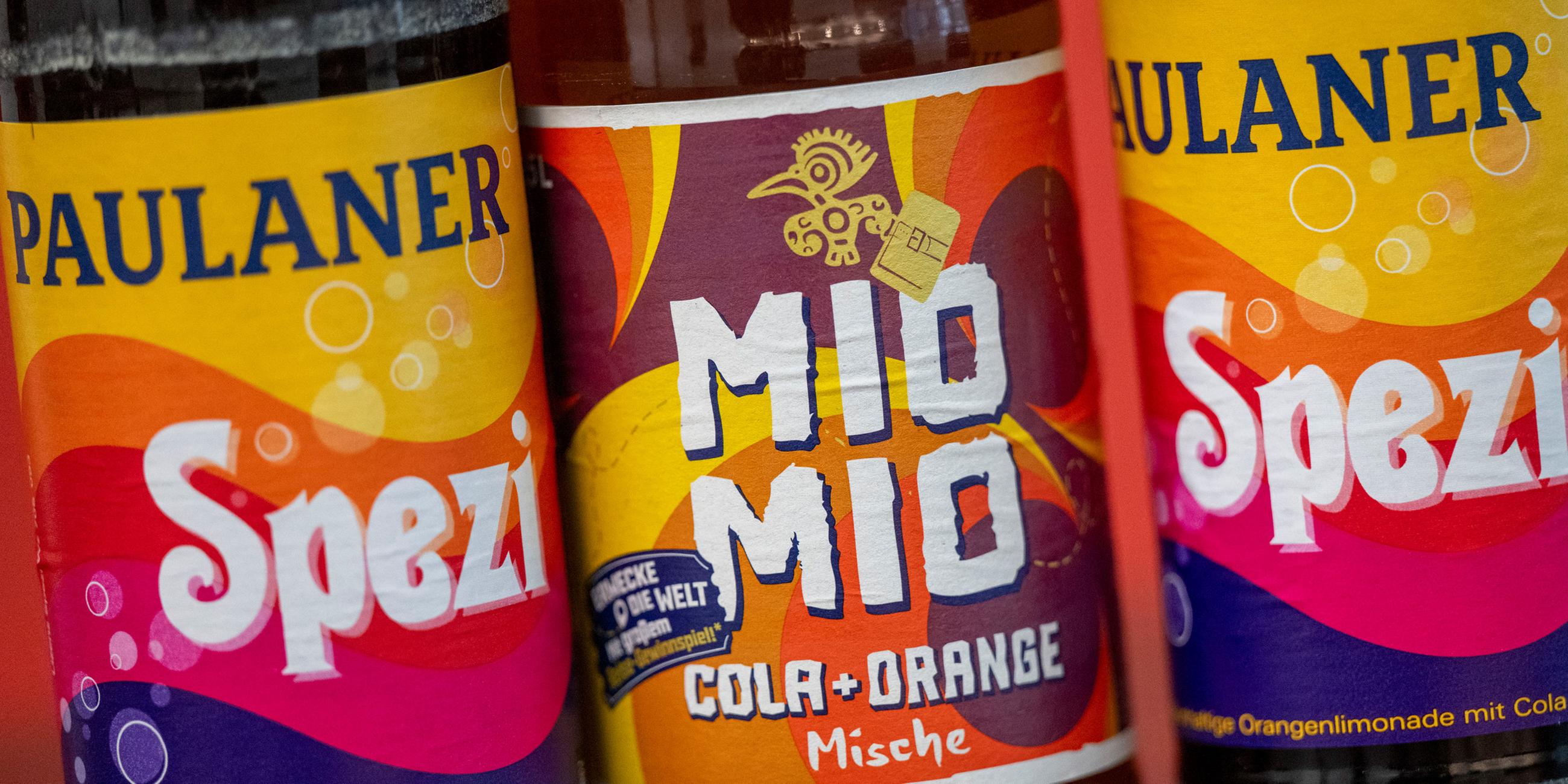  Zwei Spezi-Flaschen des Herstellers Paulaner stehen neben einer Flasche Mio-Mio-Cola-Orange-Mische (M) des Herstellers Berentzen.