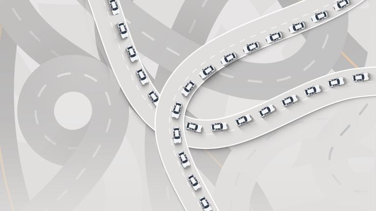 Auf der Illustration ist ein fiktives Autobahnnetz zu sehen. Auf vielen Bahnen stehen Autos dicht aneinander, sie stehen im Stau.