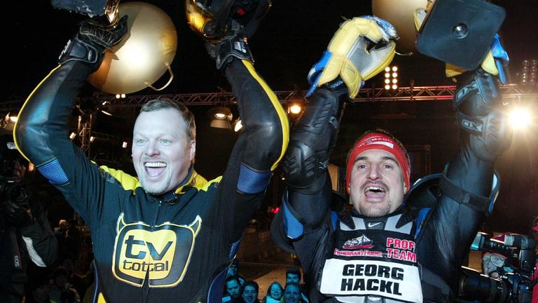 Stefan Raab und Georg Hackl halten ihre Pokale in die Höhe bei der Siegerehrung der Wok-WM 2005