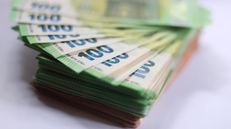 100-Euro-Banknoten liegen auf einem Tisch. 