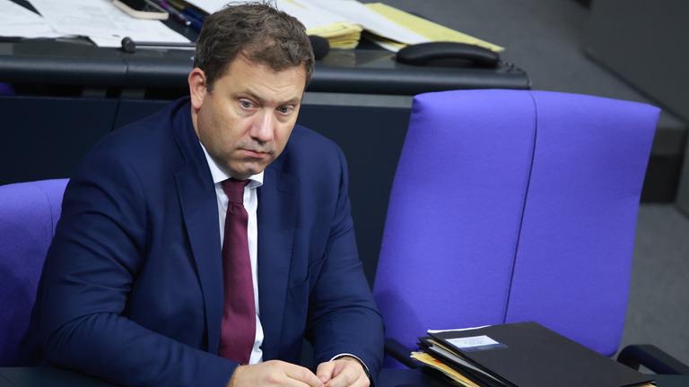 Lars Klingbeil sitzt im Bundestag, neben ihm ein leerer blauer Stuhl.