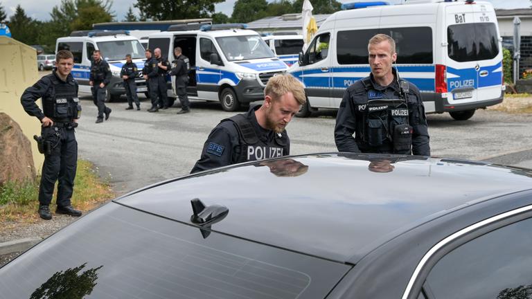 Polizisten kontrollieren auf einer Zufahrtsstraaße Autofahrer die in den Ort Stößen wollen.