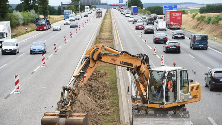 Bagger auf der Autobahn, Baustelle verursacht Stau