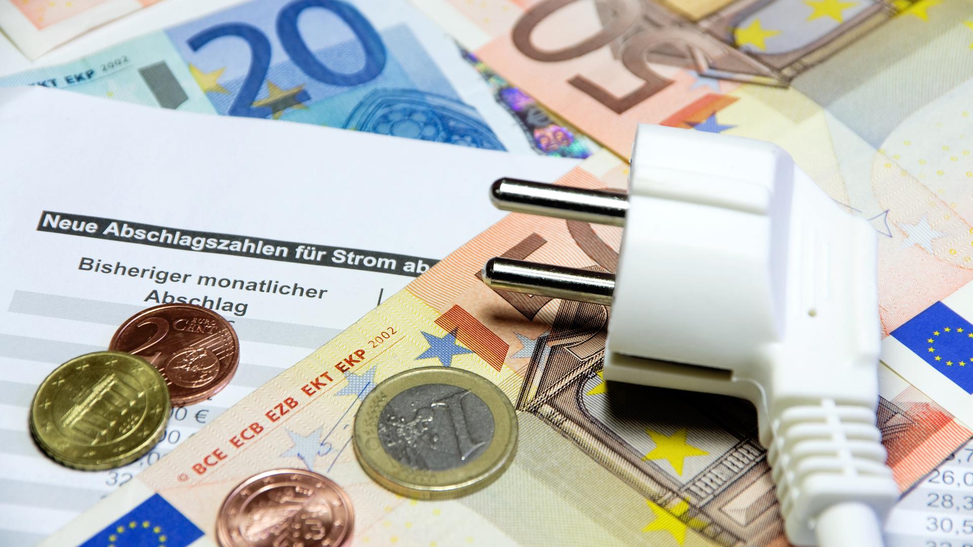 Ein Stromstecker liegt aufEuro- Geldscheinen