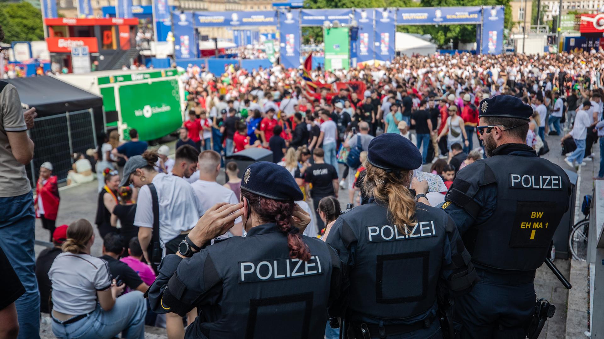 Einsatzkräfte der Polizei beobachten die Lage an der Fan Zone am Schlossplatz in Stuttgart.