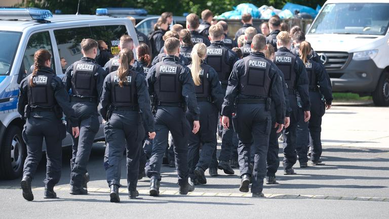 Polizisten versammeln sich auf einem Parkplatz am 06.06.2024-