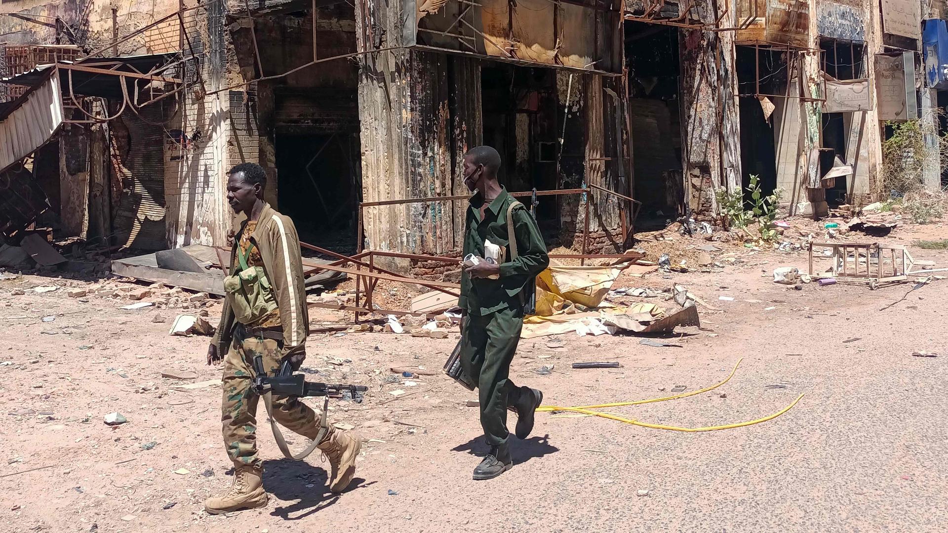 Fighters loyal to the army patrol a market area in Khartoum on March 24, 2025. 