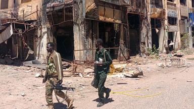 Fighters loyal to the army patrol a market area in Khartoum on March 24, 2025. 