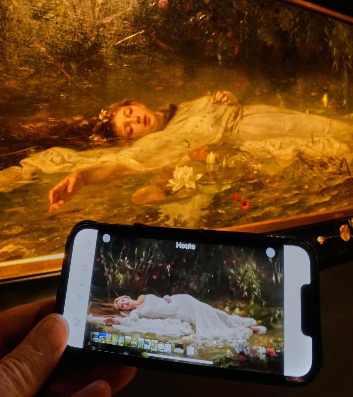 The opening part of Taylor Swift's video "The Fate of Ophelia" is displayed on a mobile phone in a museum showing a painting by Art Nouveau painter Friedrich Heyser showing Ophelia, a Shakespeare Character, in Wiesbaden, Germany