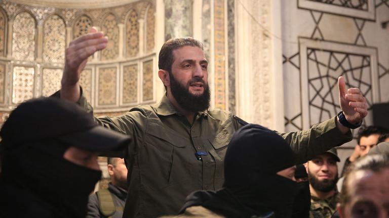 The leader of Syria's Islamist Hayat Tahrir al-Sham (HTS) group that headed a lightning rebel offensive snatching Damascus from government control, Abu Mohammed al-Jolani, address a crowd at the capital's landmark Umayyad Mosque on December 8, 2024.