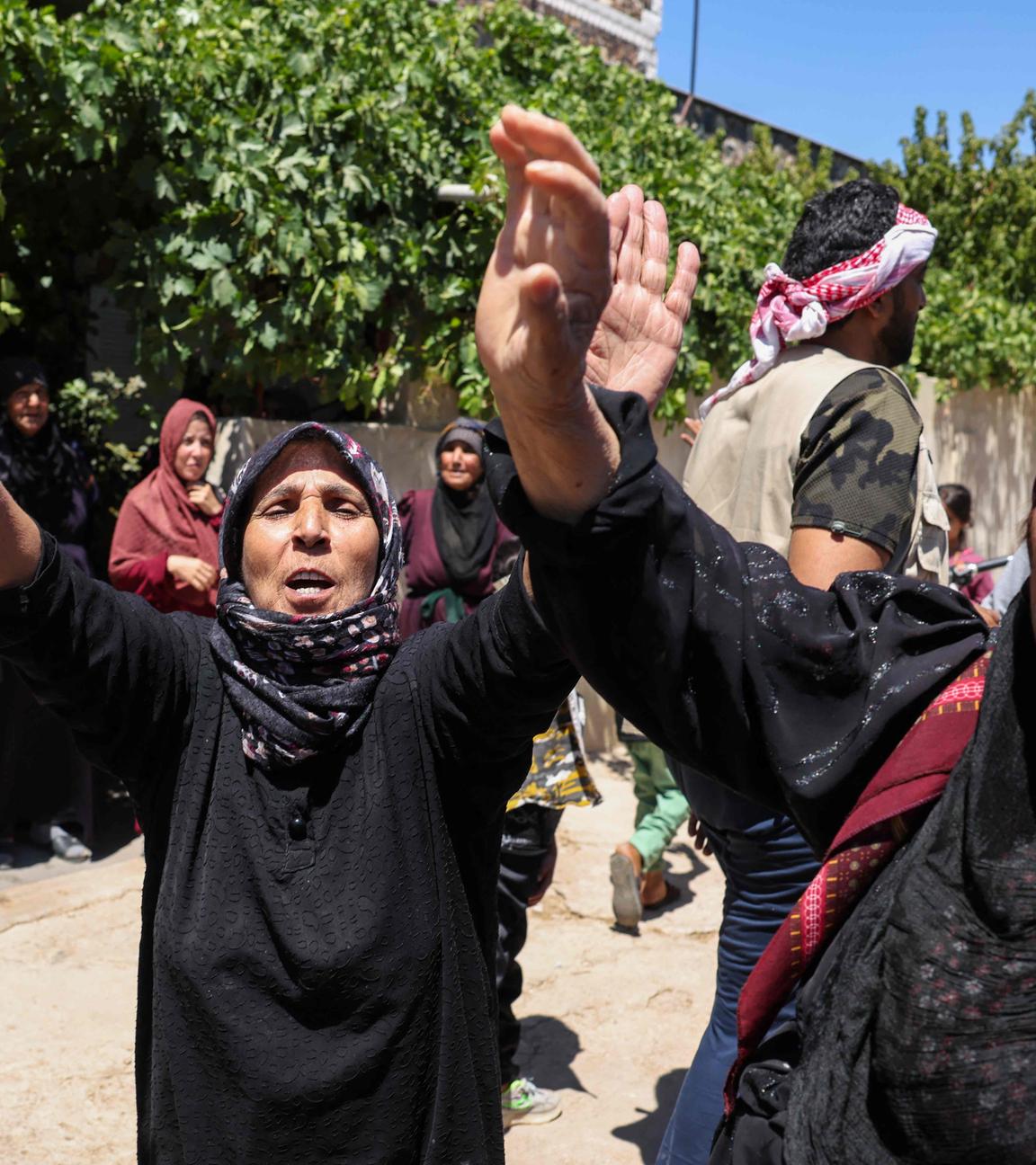 People celebrate in the predominantly Bedouin-inhabited al-Mouqawwas neighbourhood in Sweida on July 15, 2025, after the arrival of members of Syria's security forces following clashes between Bedouin tribes and Druze fighters.