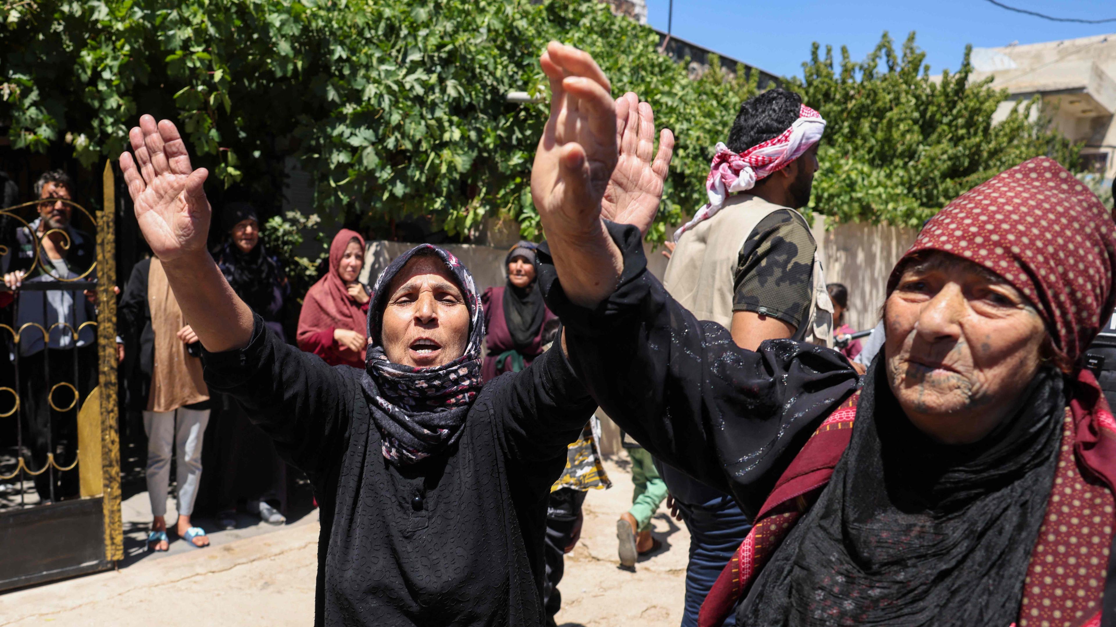 People celebrate in the predominantly Bedouin-inhabited al-Mouqawwas neighbourhood in Sweida on July 15, 2025, after the arrival of members of Syria's security forces following clashes between Bedouin tribes and Druze fighters.