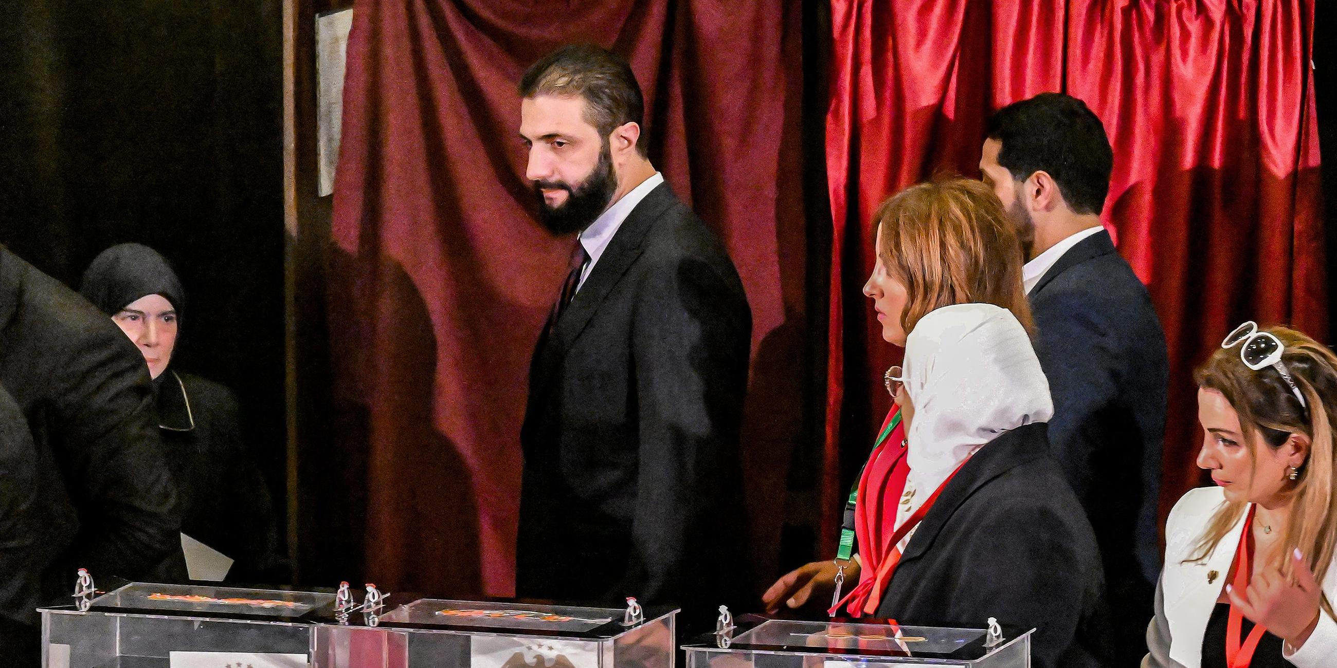 Syria's interim President Ahmed al-Sharaa visits a polling station where members of Syrian local committees have been casting their votes in the country's selection process to designate an interim parliament.