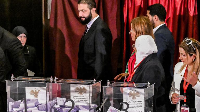 Syria's interim President Ahmed al-Sharaa visits a polling station where members of Syrian local committees have been casting their votes in the country's selection process to designate an interim parliament.