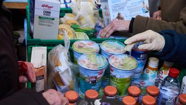 Lebensmittel werden bei der Essensausgabe der "Tafel" gereicht 