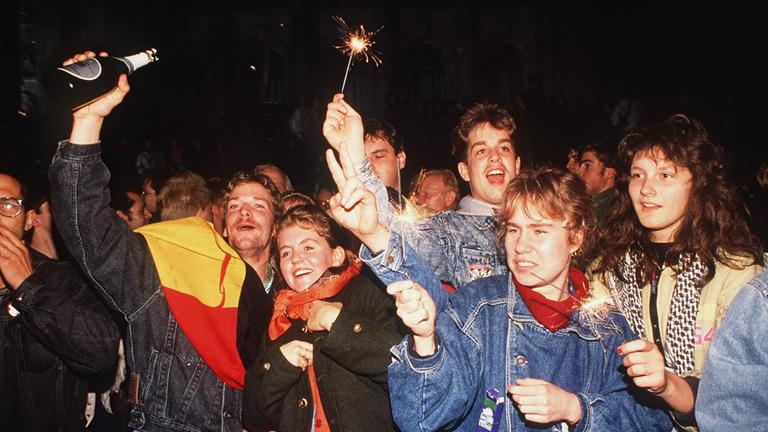 Deutsche feiern am 3. Oktober 1990 in Berlin die Wiedervereinigung Deutschlands.