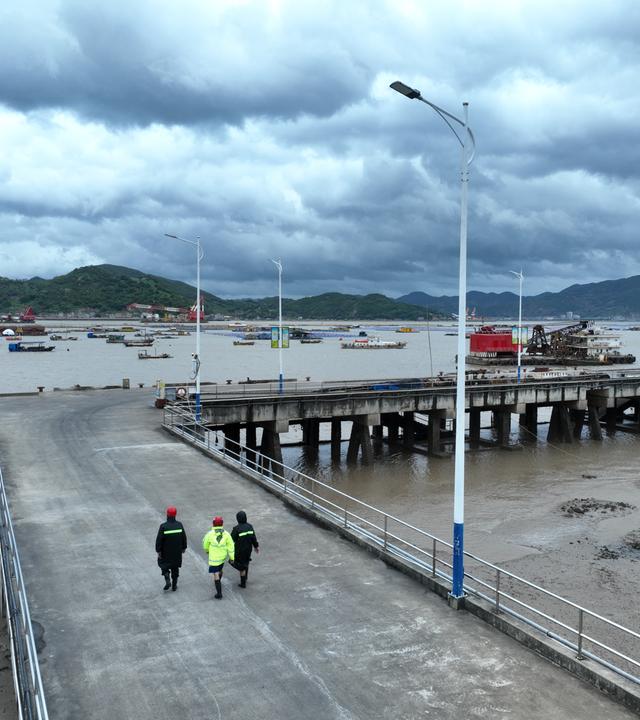 11.07.2026, China, Fuding: Dorfbeamte und Rettungskräfte gehen bei einem Patrouilleneinsatz in der südostchinesischen Provinz Fujian.
