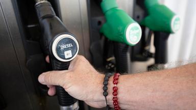 Baden-Württemberg, Burladingen: Ein Mann nimmt einen Zapfhahn an der Trigema-Tankstelle in Burladingen in die Hand.
