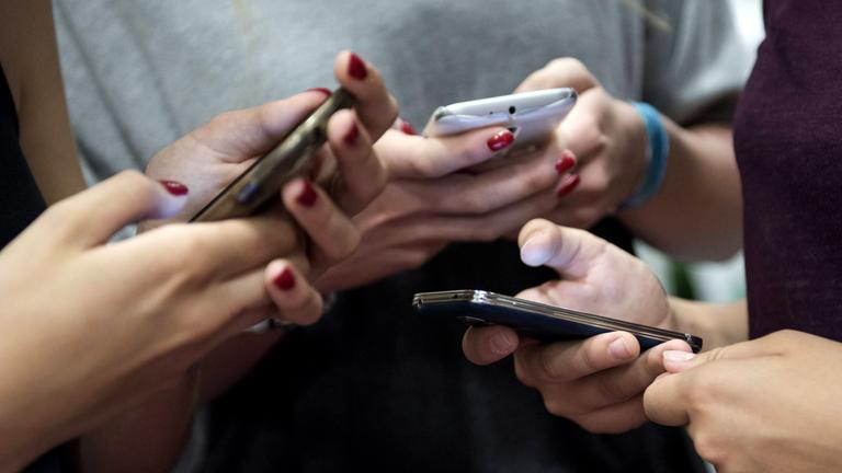 Eine Gruppe Teenager mit ihren Smartphones