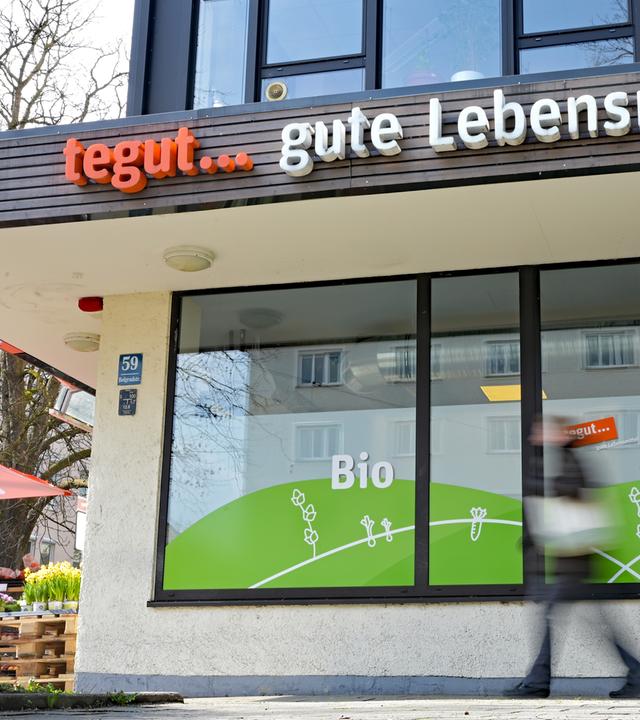 Eine Person läuft an einer tegut-Filiale vorbei. 