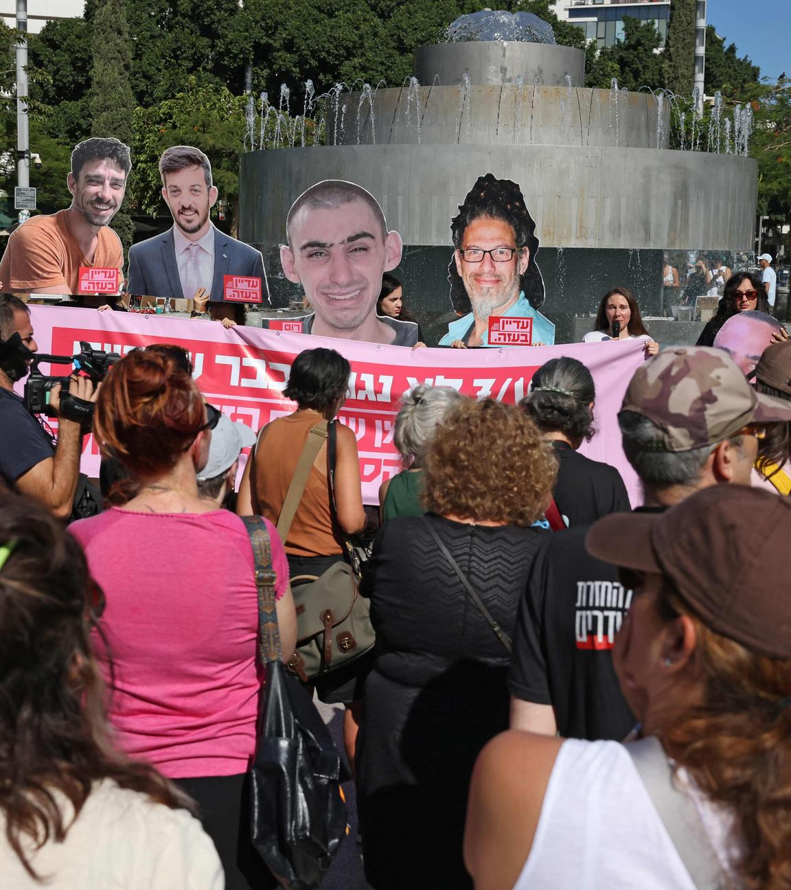 People lift placards and portraits of Israelis held hostage in the Gaza Strip since 2023, during a rally in Tel Aviv marking the second anniversary of the attacks by Palestinian militants, on October 7, 2025.