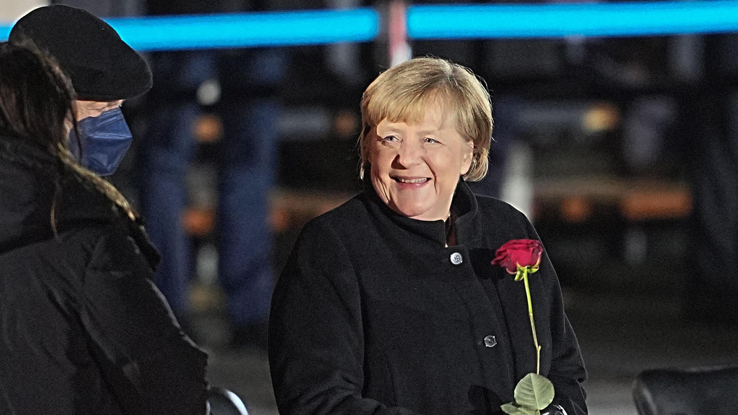 Angela Merkel mit roter Rose nach ihrem Großen Zapfenstreich.