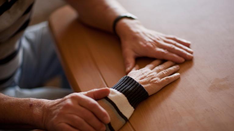 Ein Angehöriger betreut eine Pflegebedürftige. Symbolbild