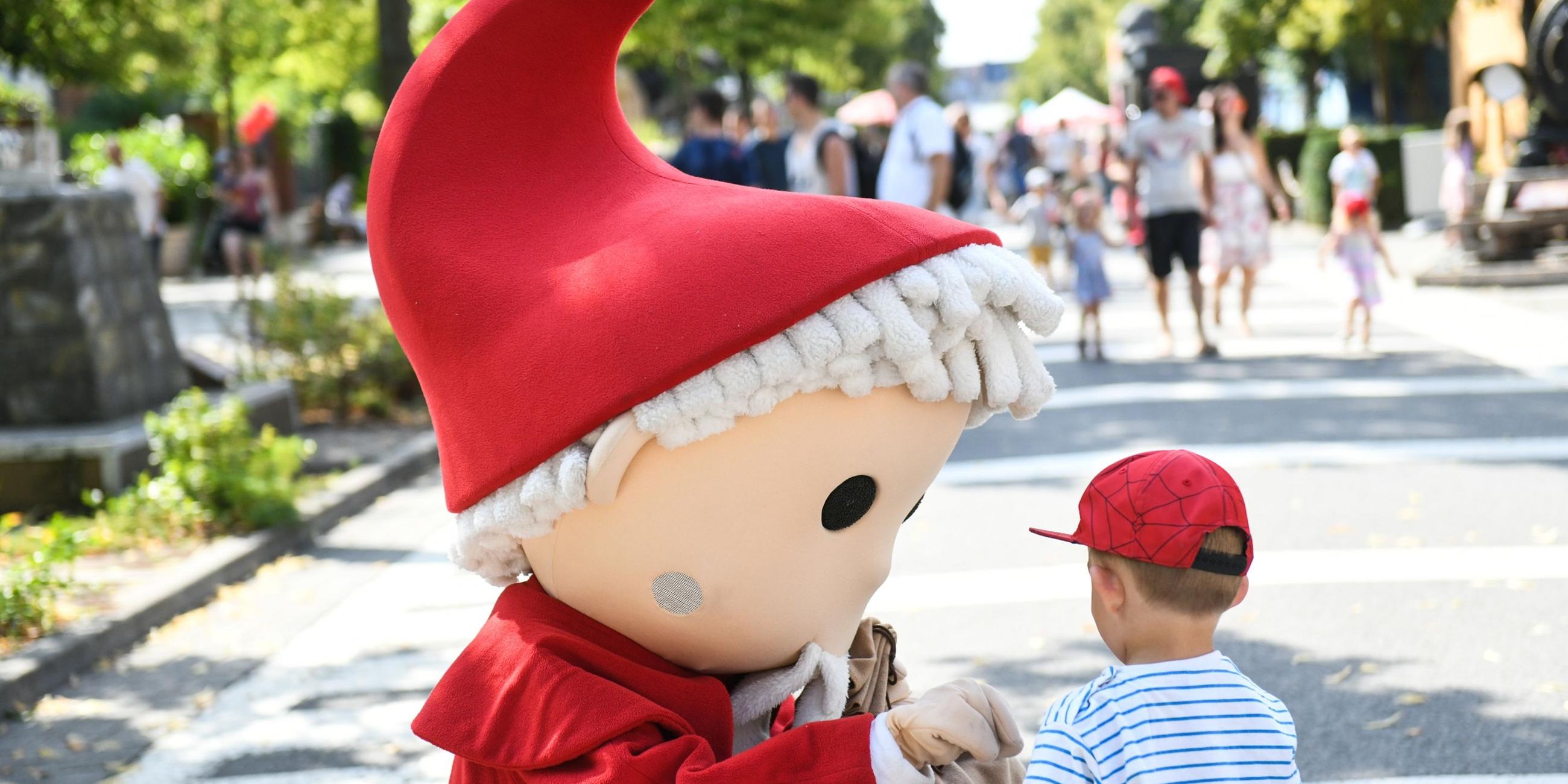 Ein Sandmännchen begrüßt einen Jungen bei dem Geburtstagsfest.