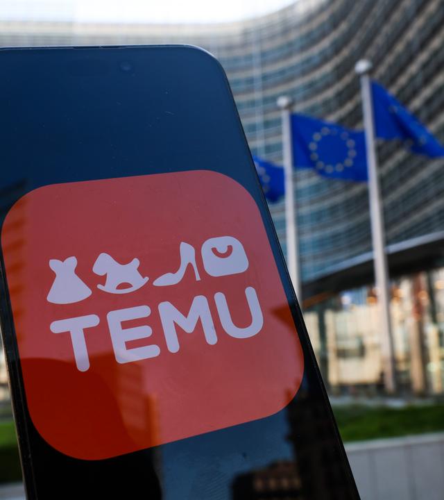 Symbolbild: Temu Logo auf Smartphone vor EU-Hauptquartier in Brüssel