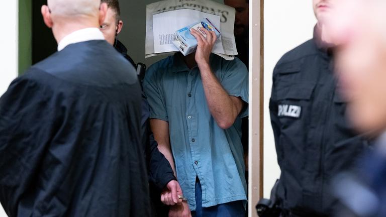 Ein wegen Mitgliedschaft in einer terroristischen Vereinigung und die Vorbereitung eines sogenannten hochverräterischen Unternehmens angeklagter Mann wird im Oberlandesgericht in den Gerichtssaal geführt.