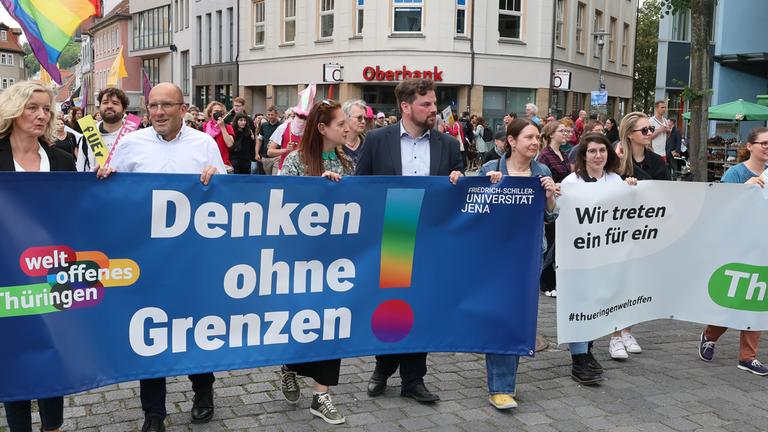Thüringen, Jena: «Denken ohne Grenzen» steht auf einem Plakat von Teilnehmern einer Demonstration unter dem Motto «Demokratie verteidigen» der Initiative «Jena solidarisch», die durch die Innenstadt laufen.