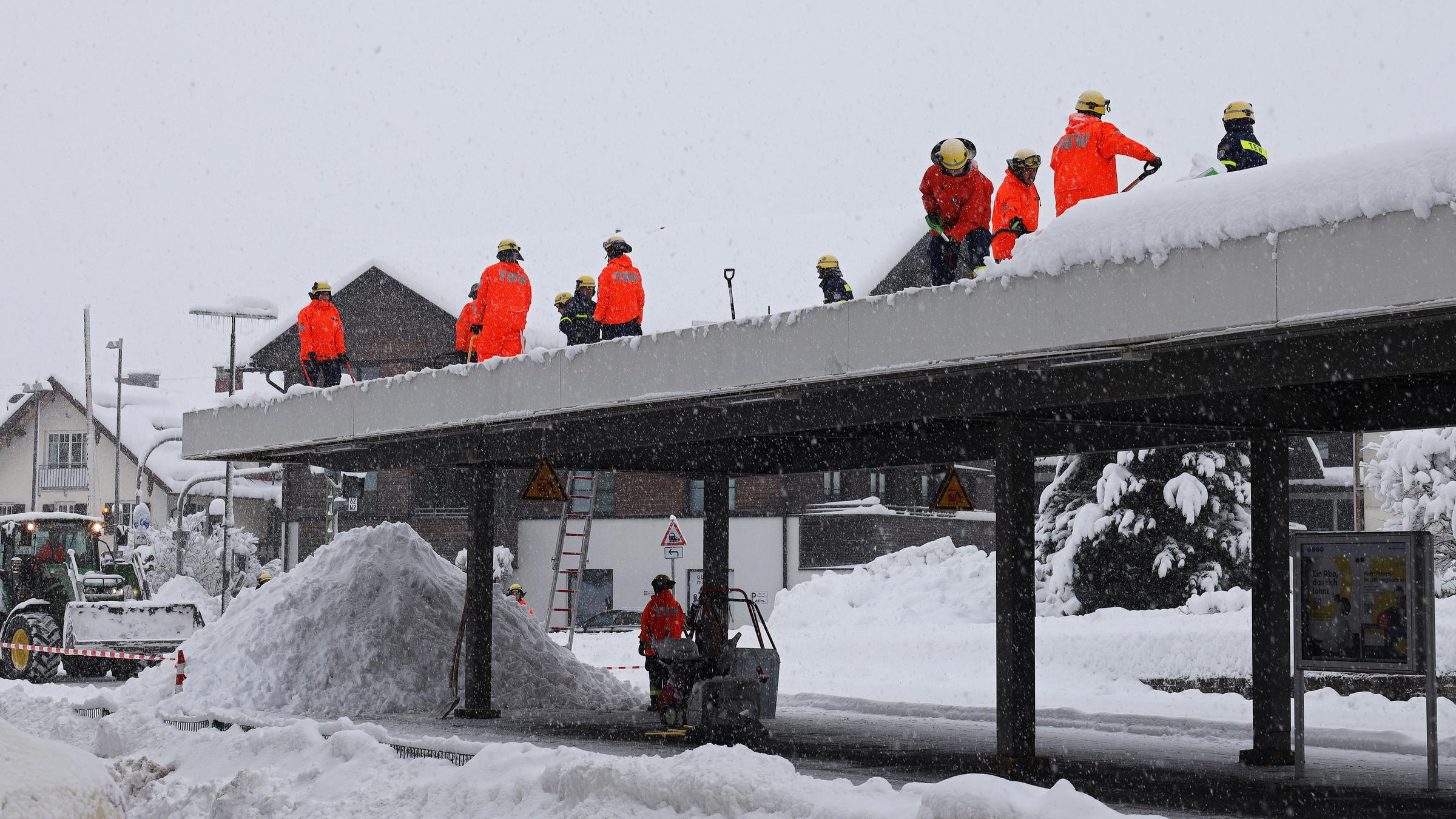 Einsatzkräfte des Technischen Hilfswerks (THW) befreien das Bahnhofsdach im Bahnhof Oberstaufen von der Schneelast