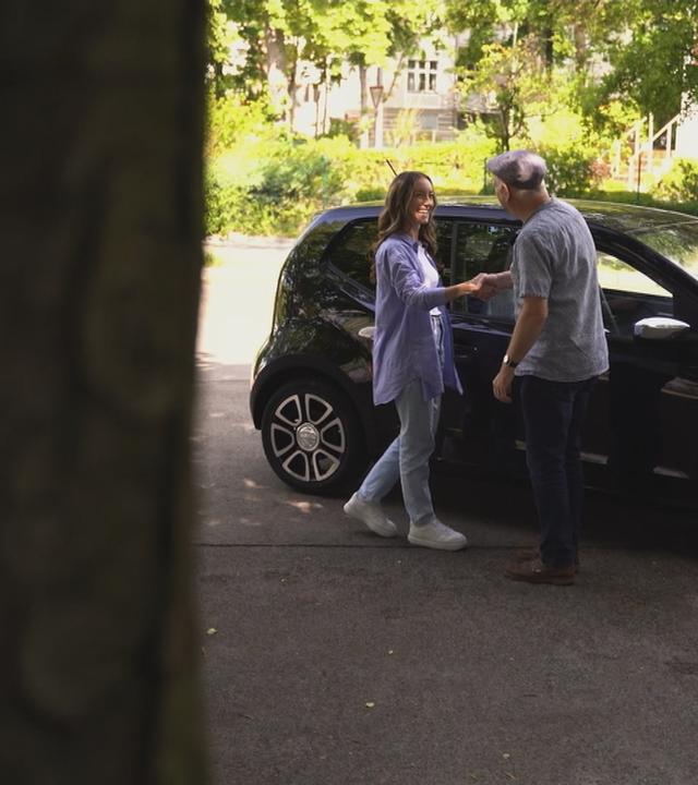 Zwei Menschen stehen vor einem Auto