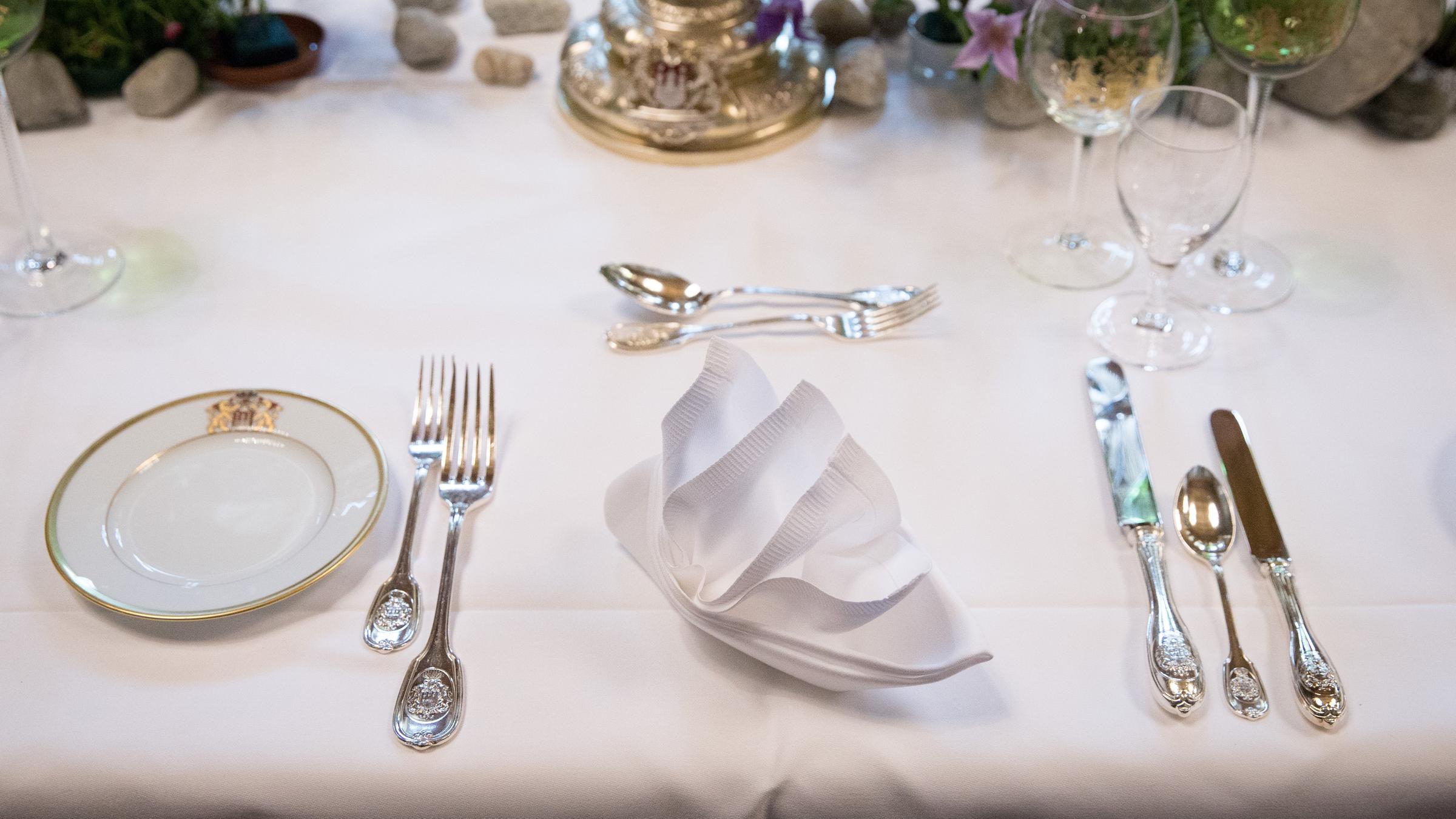 Ein mit Teller, Besteck und Gläsern gedeckter Tisch.