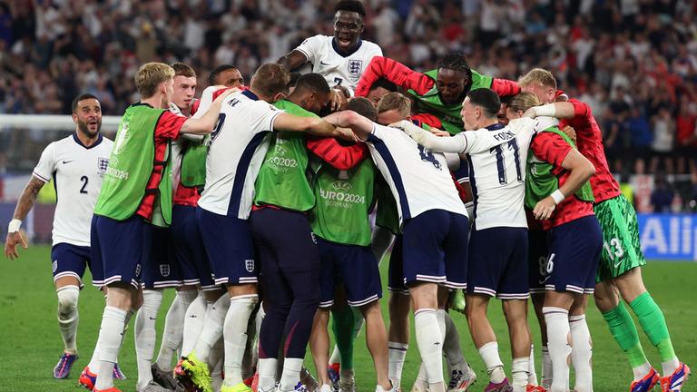 England's players celebrate after winning the UEFA Euro 2024 semi-final football match