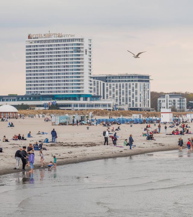 Menschen genießen milde Temperaturen am Strand von Warnemünde in Rostock, Mecklenburg-Vorpommern, am 18.04.2026.