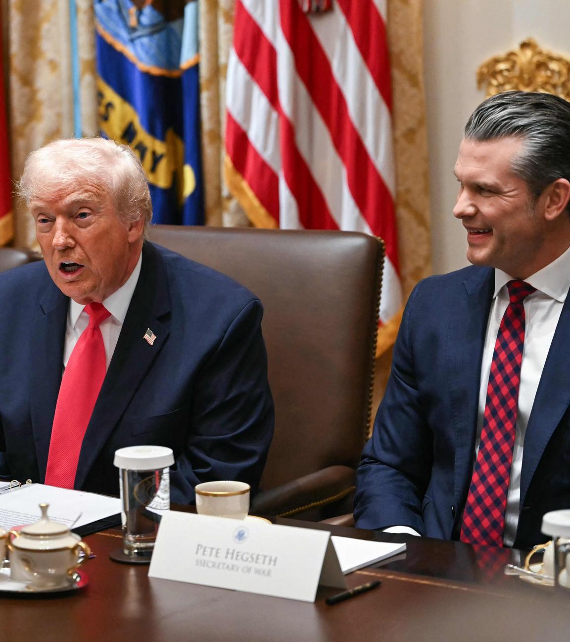 US President Donald Trump (C), flanked by Secretary of State Marco Rubio (L) and Secretary of Defense Pete Hegseth (R), speaks during a Cabinet Meeting in the Cabinet Room of the White House in Washington
