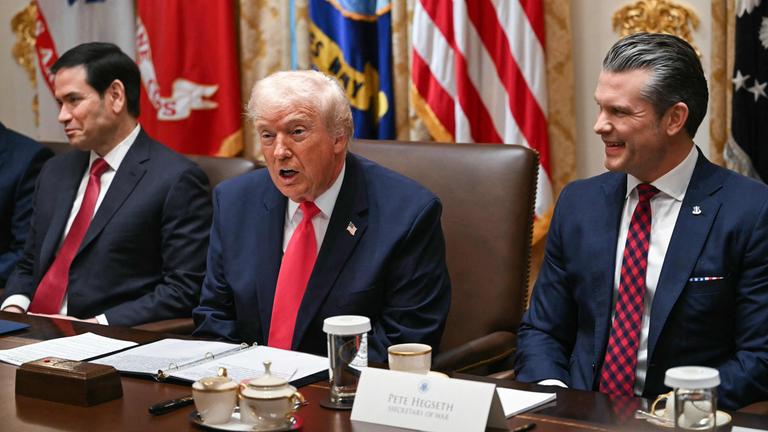 US President Donald Trump (C), flanked by Secretary of State Marco Rubio (L) and Secretary of Defense Pete Hegseth (R), speaks during a Cabinet Meeting in the Cabinet Room of the White House in Washington