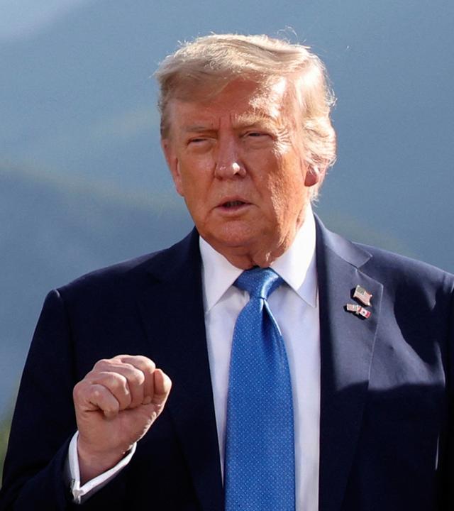 U.S. President Donald Trump gestures as he attends a family photo session during the G7 Summit, in Kananaskis, Alberta, Monday, June 16, 2025. 