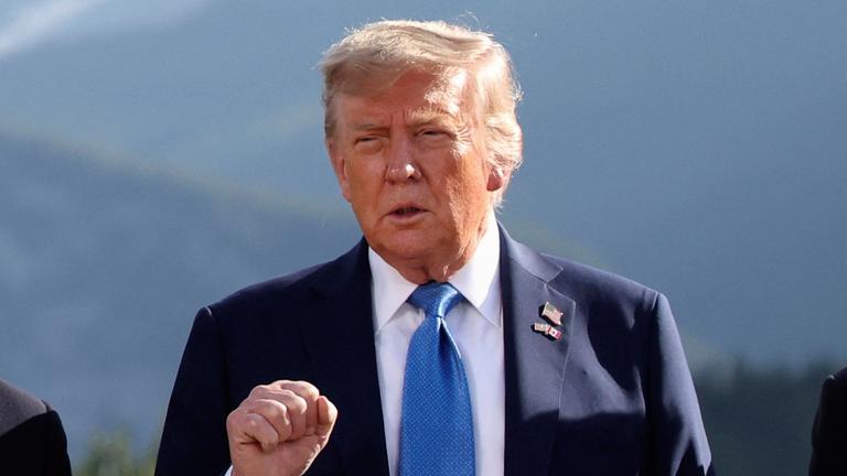 U.S. President Donald Trump gestures as he attends a family photo session during the G7 Summit, in Kananaskis, Alberta, Monday, June 16, 2025. 