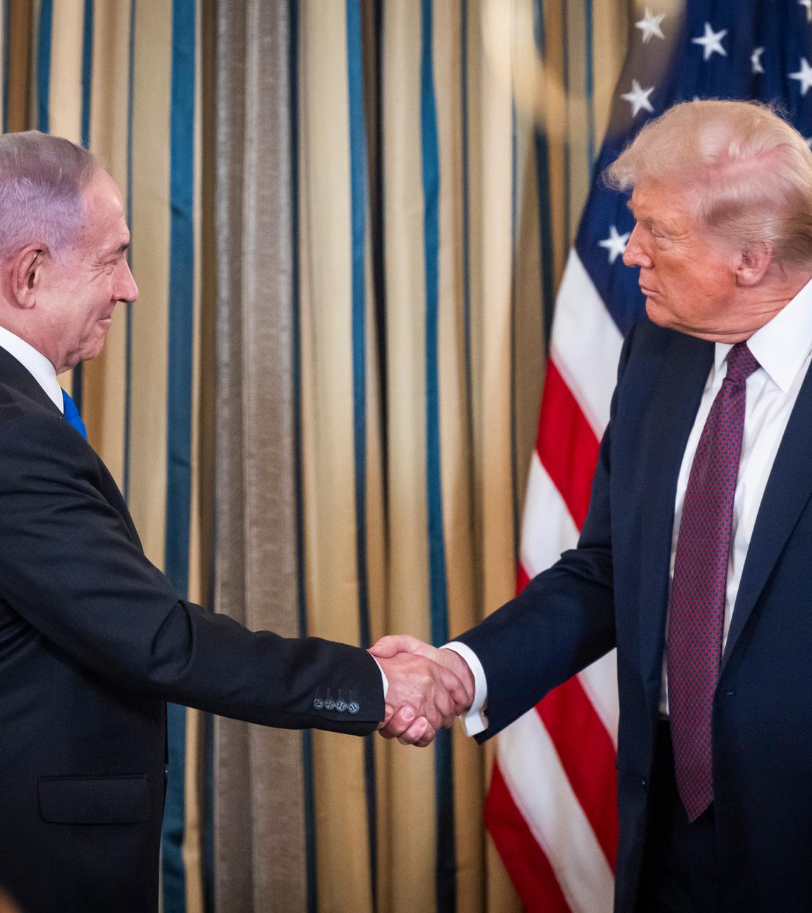 US President Donald Trump (R) shakes hands with Israeli Prime Minister Benjamin Netanyahu (L) after they spoke at a press conference in the State Dining Room of the White House in Washington, DC