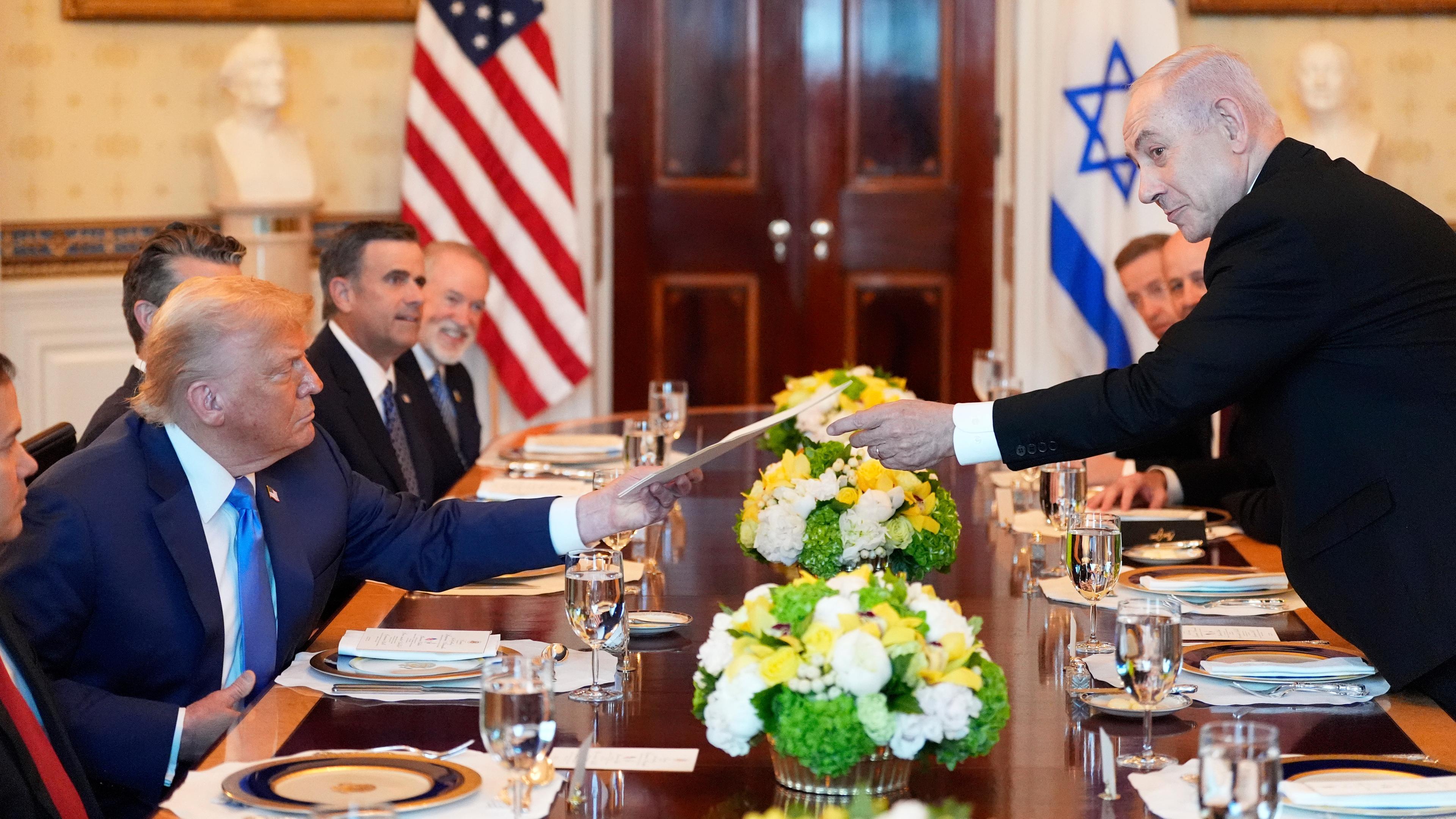 Israels Ministerpräsident Benjamin Netanjahu überreicht US-Präsident Donald Trump eine Mappe